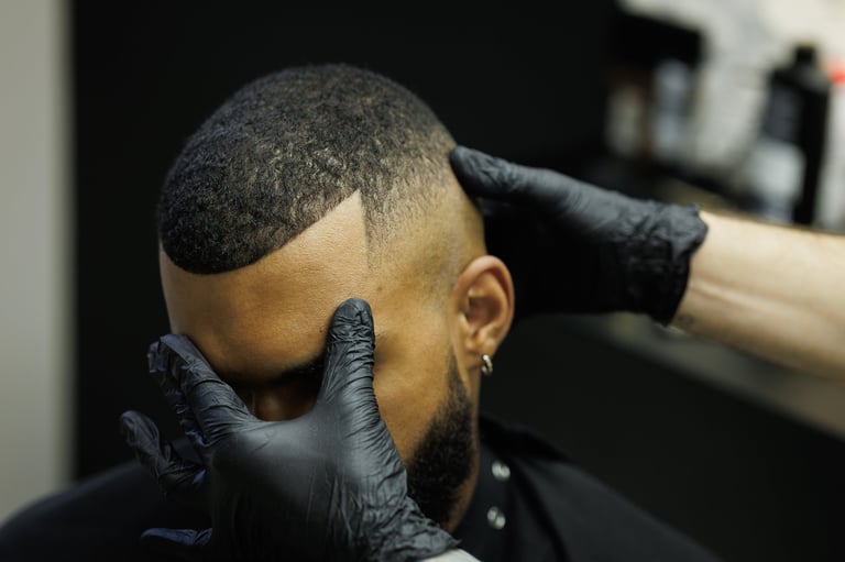 Barber checking haircut of client